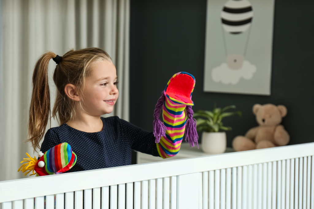 Little Girl Putting On a Puppet Show